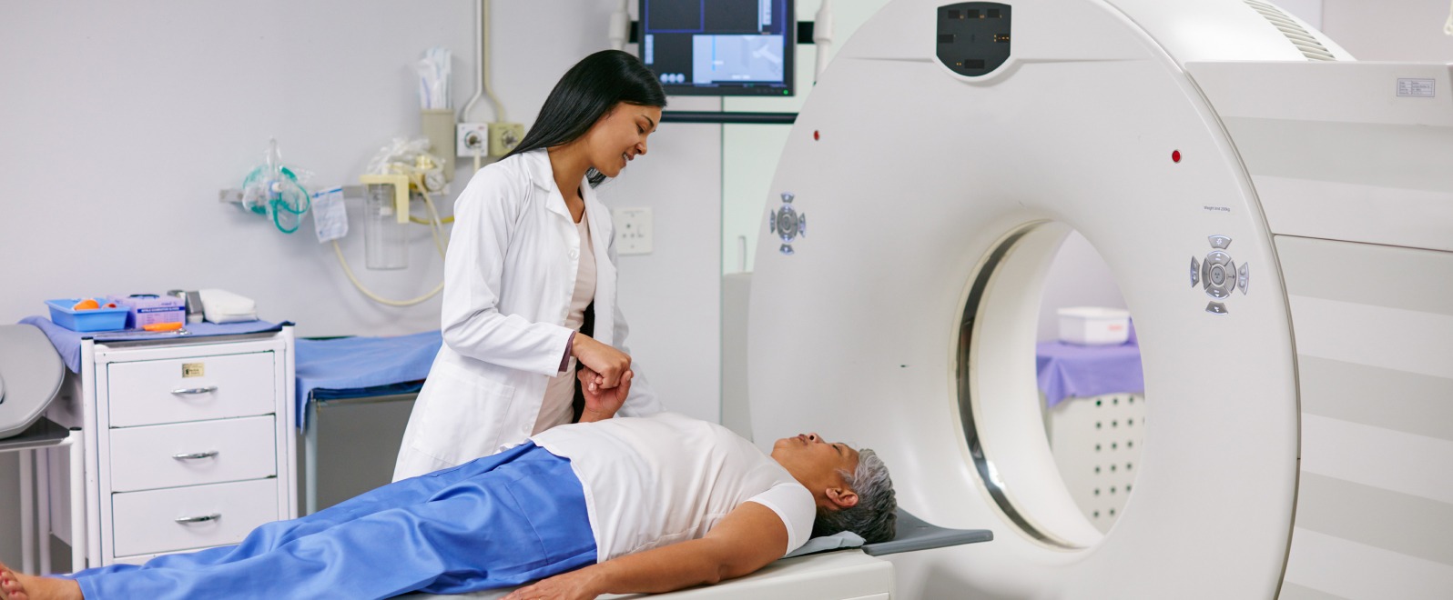 skaner DEXA ustawiony nad dolną częścią pleców pacjentki na stole