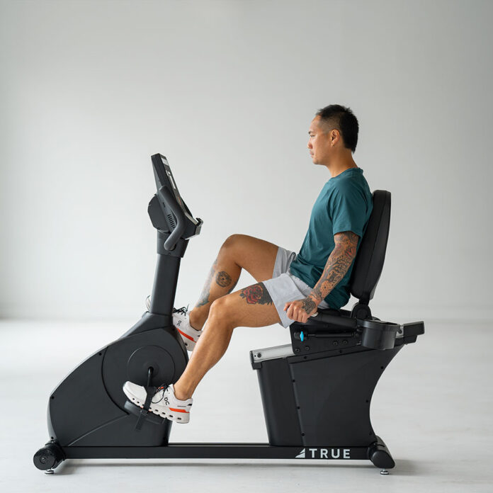 Rower rehabilitacyjny ustawiony w jasnej, domowej sali do ćwiczeń